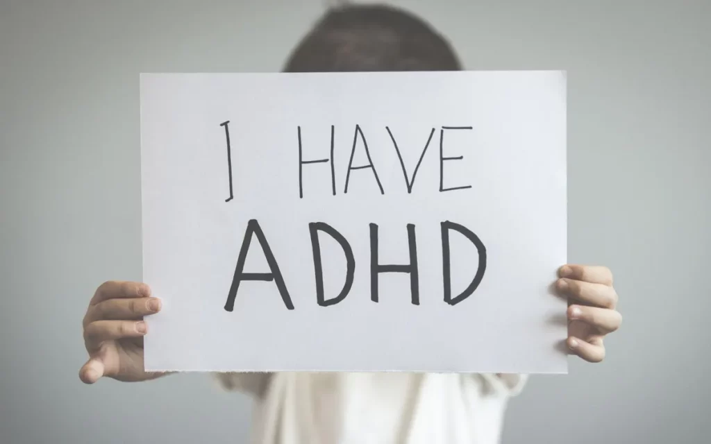 Kid with a sign saying "I have ADHD"